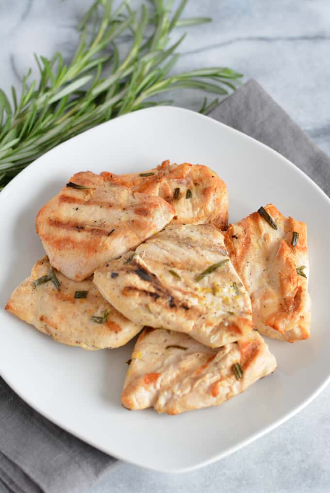 Grilled Lemon Rosemary Chicken Breast on a white plate. 