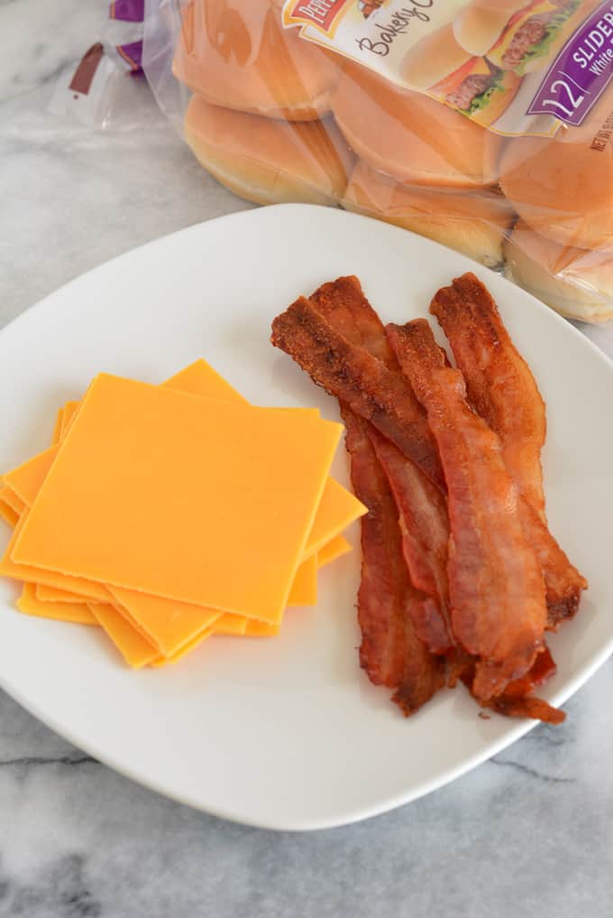 Bacon Cheddar Cheeseburger Sliders are the perfect game day snack. Baked in the oven there is no need to turn on your grill. Pepperidge farm sliders make game day easy. #sponsored #easyrecipes #gamedayrecipes #respectthebun #snacks #sliders #burgers