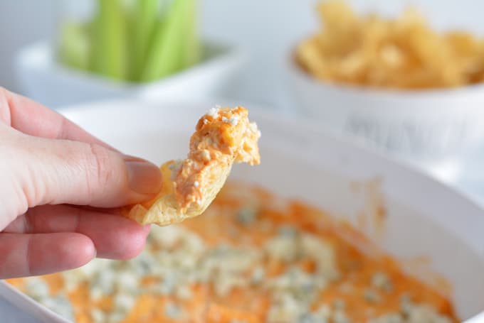 A scoop of baked buffalo chicken dip on a chip.
