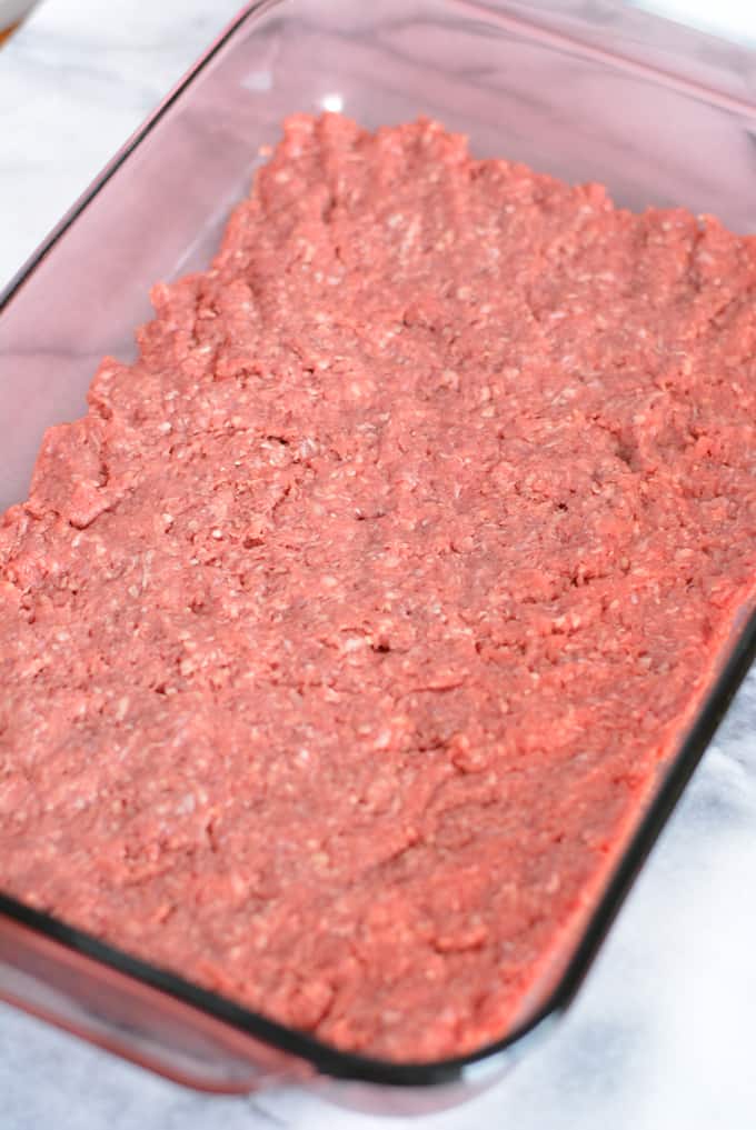 Raw ground beef in a baking pan.