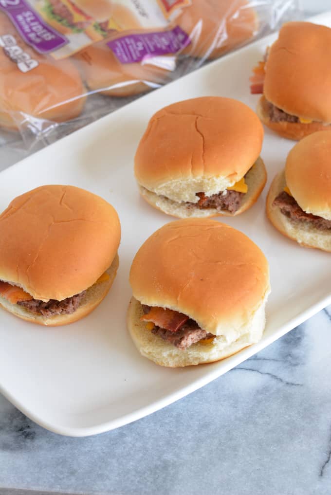 Bacon Cheddar Cheeseburger Sliders are the perfect game day snack. Baked in the oven there is no need to turn on your grill. Pepperidge farm sliders make game day easy. #sponsored #easyrecipes #gamedayrecipes #respectthebun #snacks #sliders #burgers