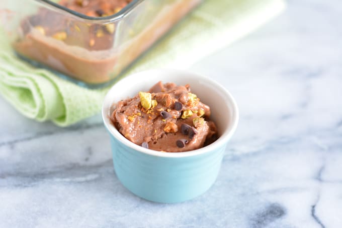 Chocolate pistachio chip nice cream with pistachios in a bowl.