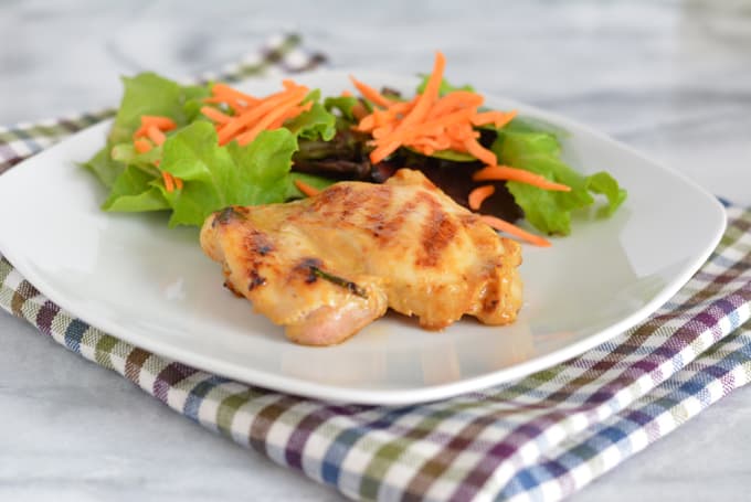 Grilled Maple Dijon Chicken Thighs on a plate with lettuce