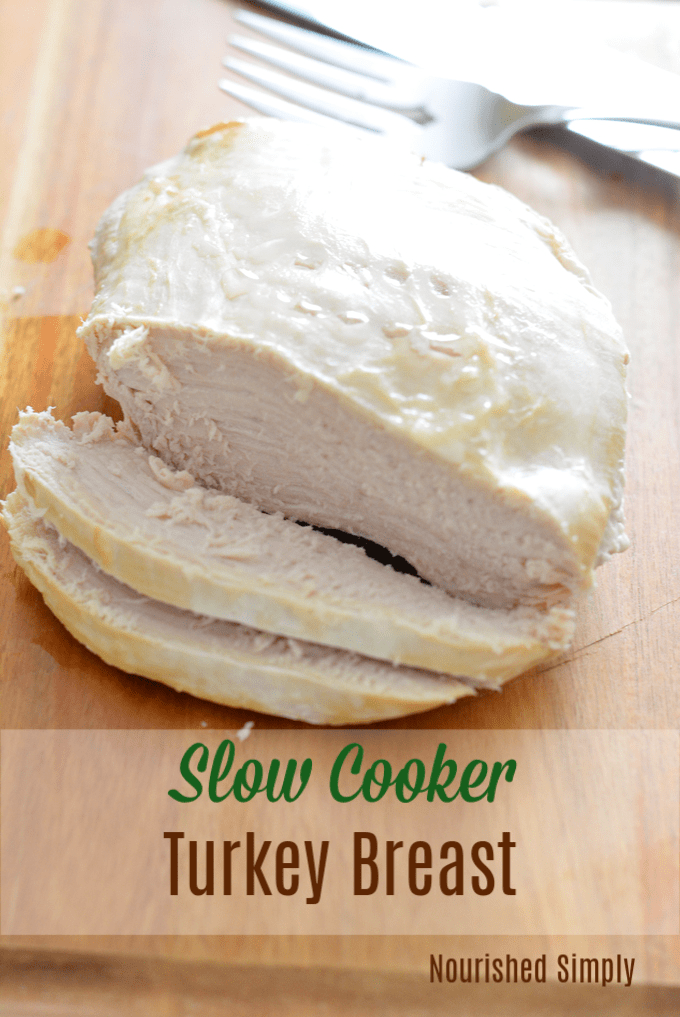 Sliced slow cooker turkey breast on a cutting board.